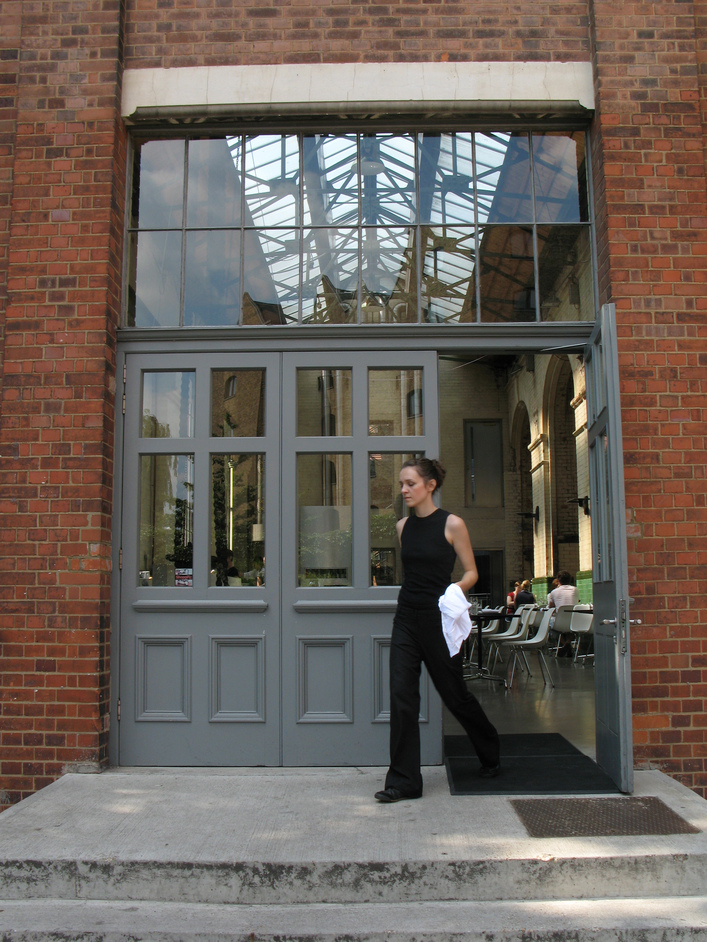 The Wapping Project - An employee exiting one of the doors into the building.