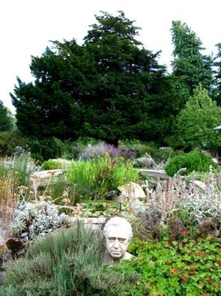 Chelsea Physic Garden - The pond rock garden which is made up of rocks from the Tower of London and icelandic lava, to name a few. The bust is that of Joseph Banks, explorer and botanist.