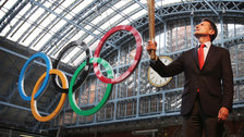 Torches & Mascots - Lord Coe holds the Olympic Torch
